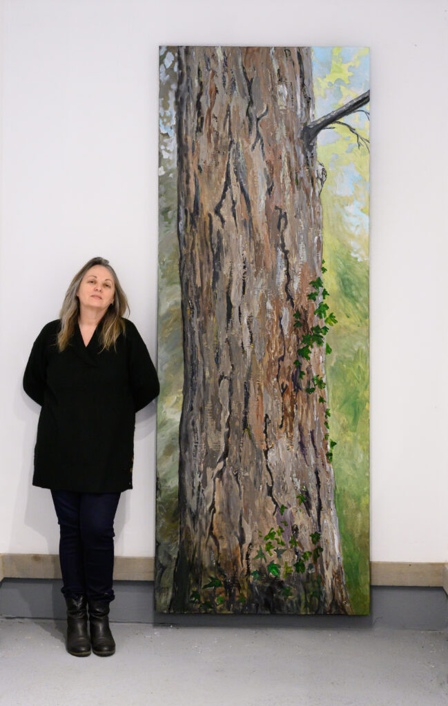 Jacqui Austin and her large painting of a local tree